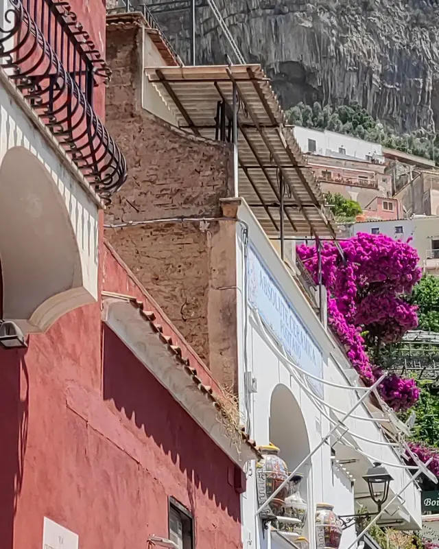 Narrow street in Positano with balconies and flowers